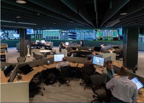 Network operations center with operator consoles and a video wall