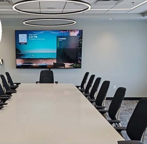 Conference room with a large display and video conferencing table