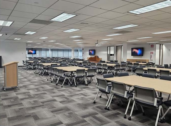 Flat-floor town hall and training space with multiple displays